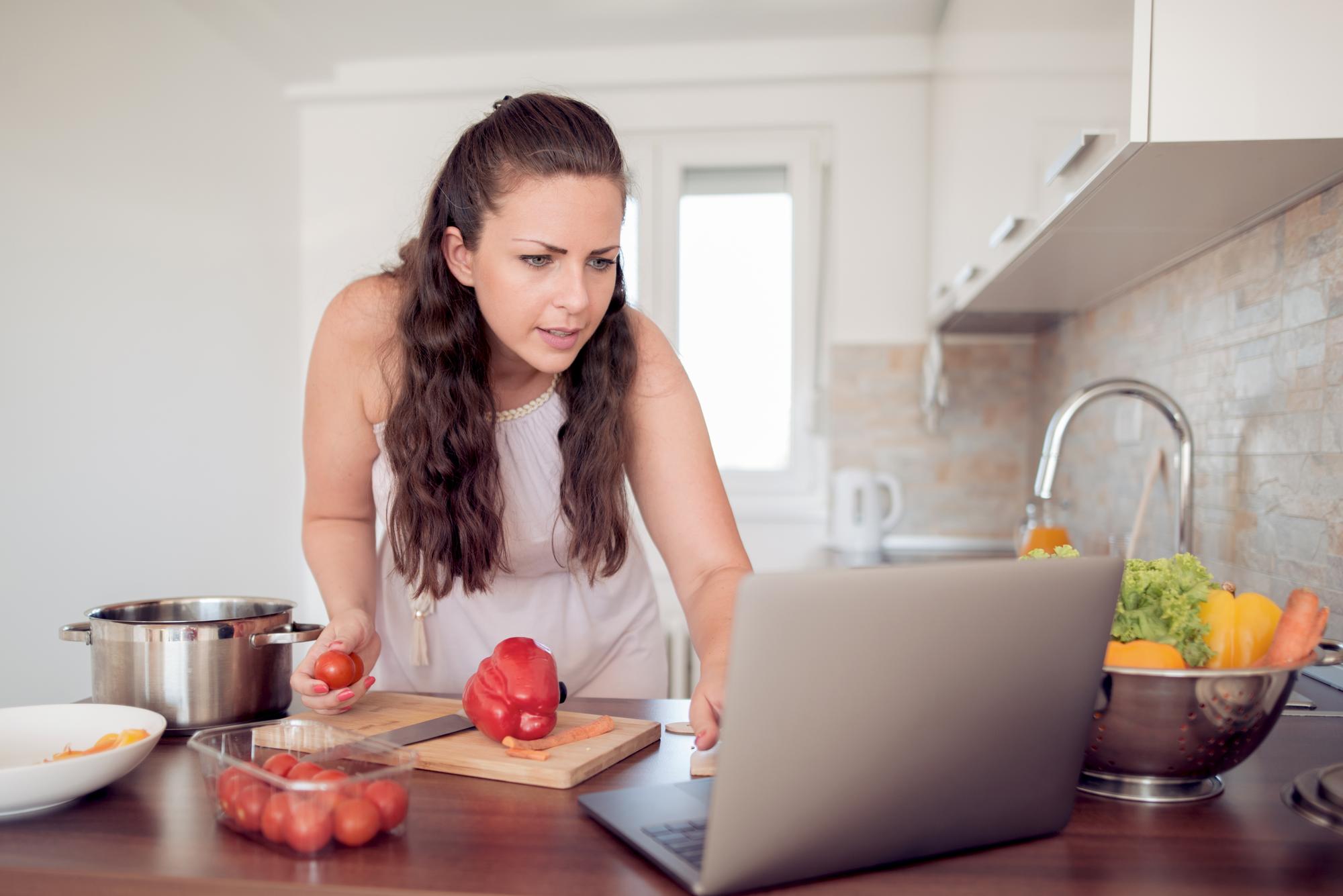 Student cooking at home station with laptop